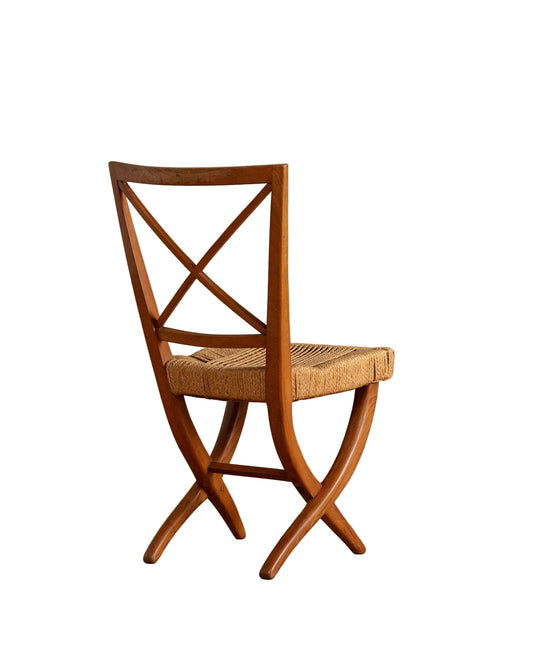 Wooden chair with woven seat on a wooden floor and beige wall background