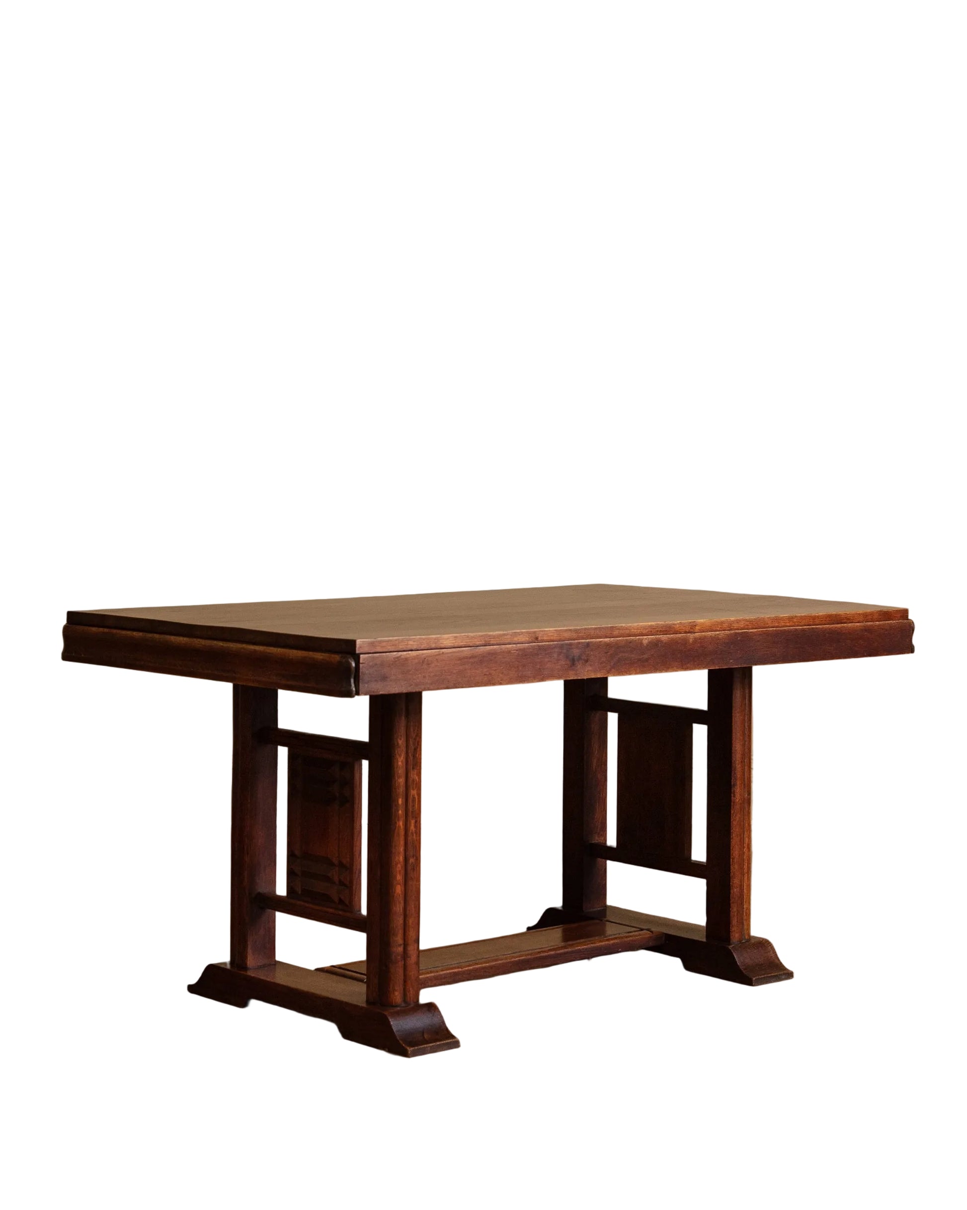 Wooden table with a rustic design on a wooden floor against a beige wall