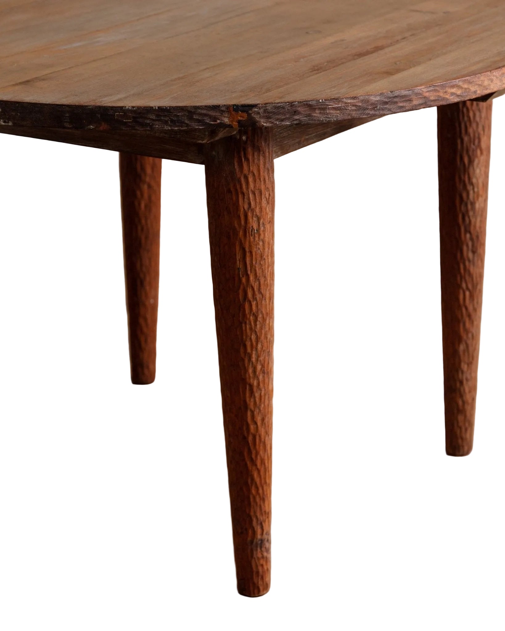 Wooden table with textured legs on a wooden floor