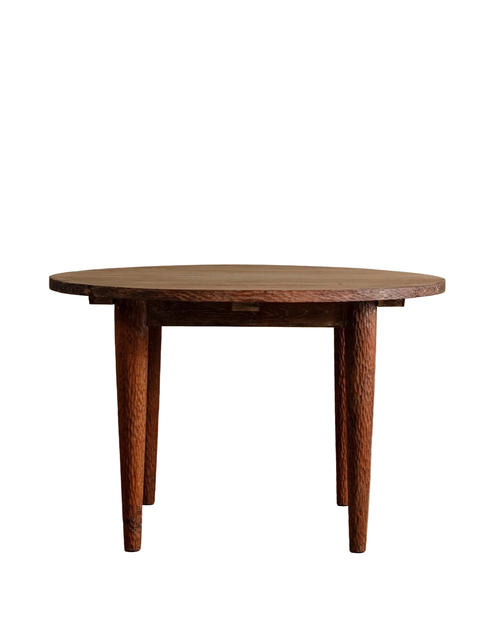 Wooden dining table against a beige wall