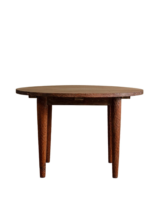 Wooden dining table against a beige wall