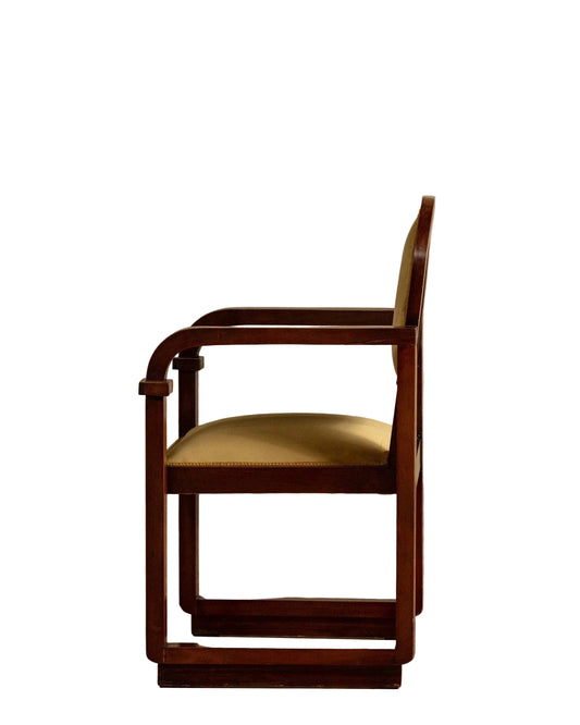 Wooden chair with a beige cushion on a wooden floor and beige wall background