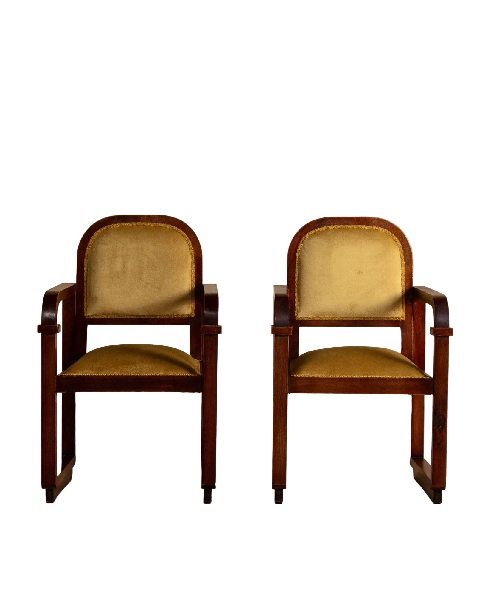 Pair of vintage wooden chairs with yellow cushioned seats on a beige background