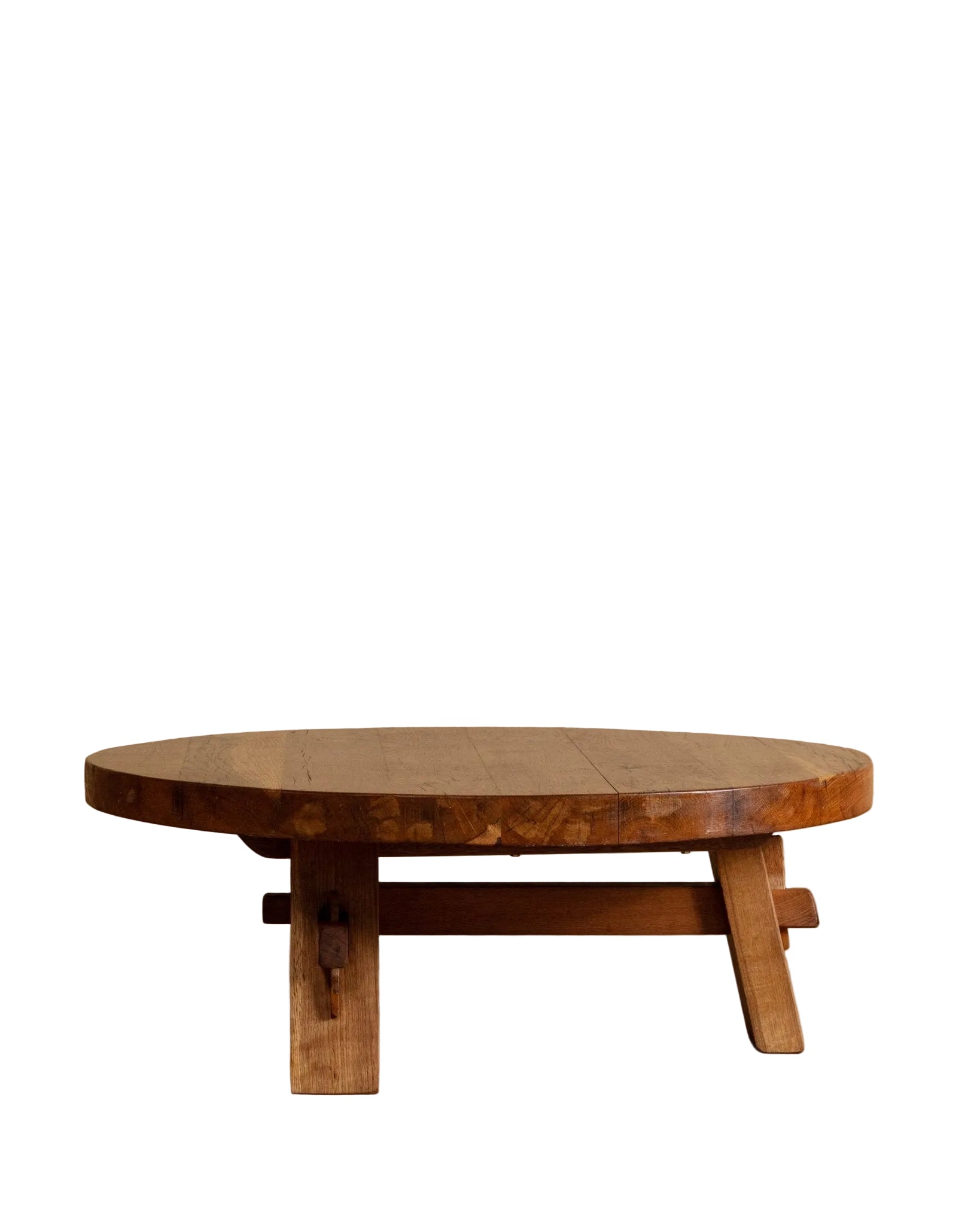 Wooden round table against a beige wall