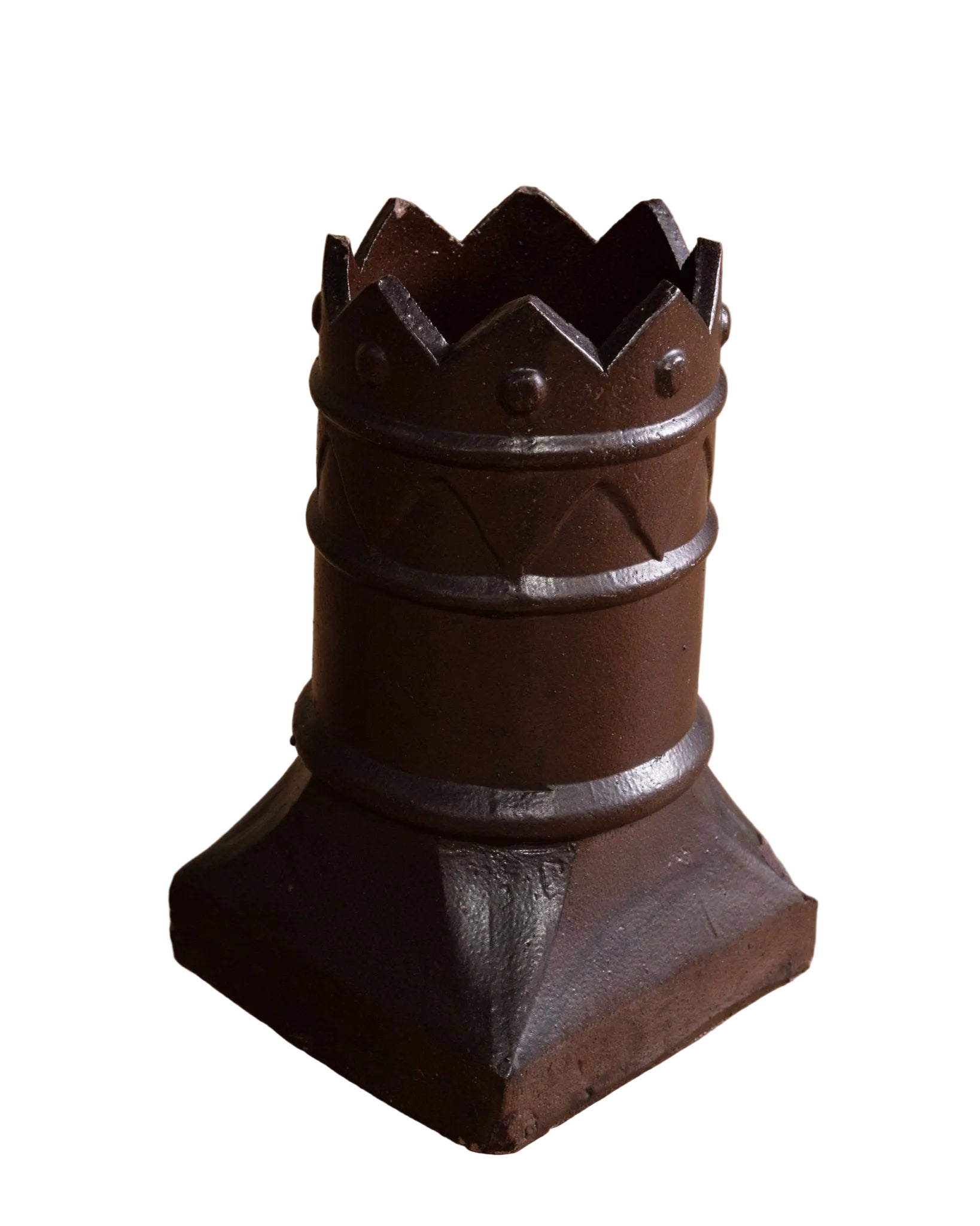Decorative metal object resembling a crown on a wooden floor
