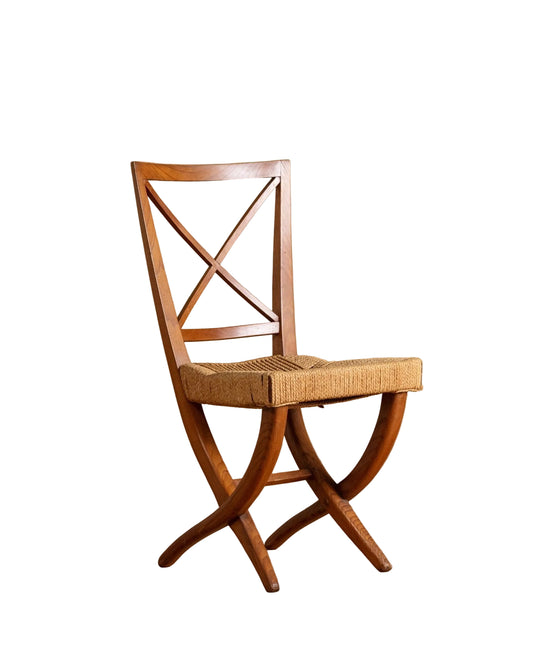 Wooden chair with woven seat on a wooden floor and beige wall background