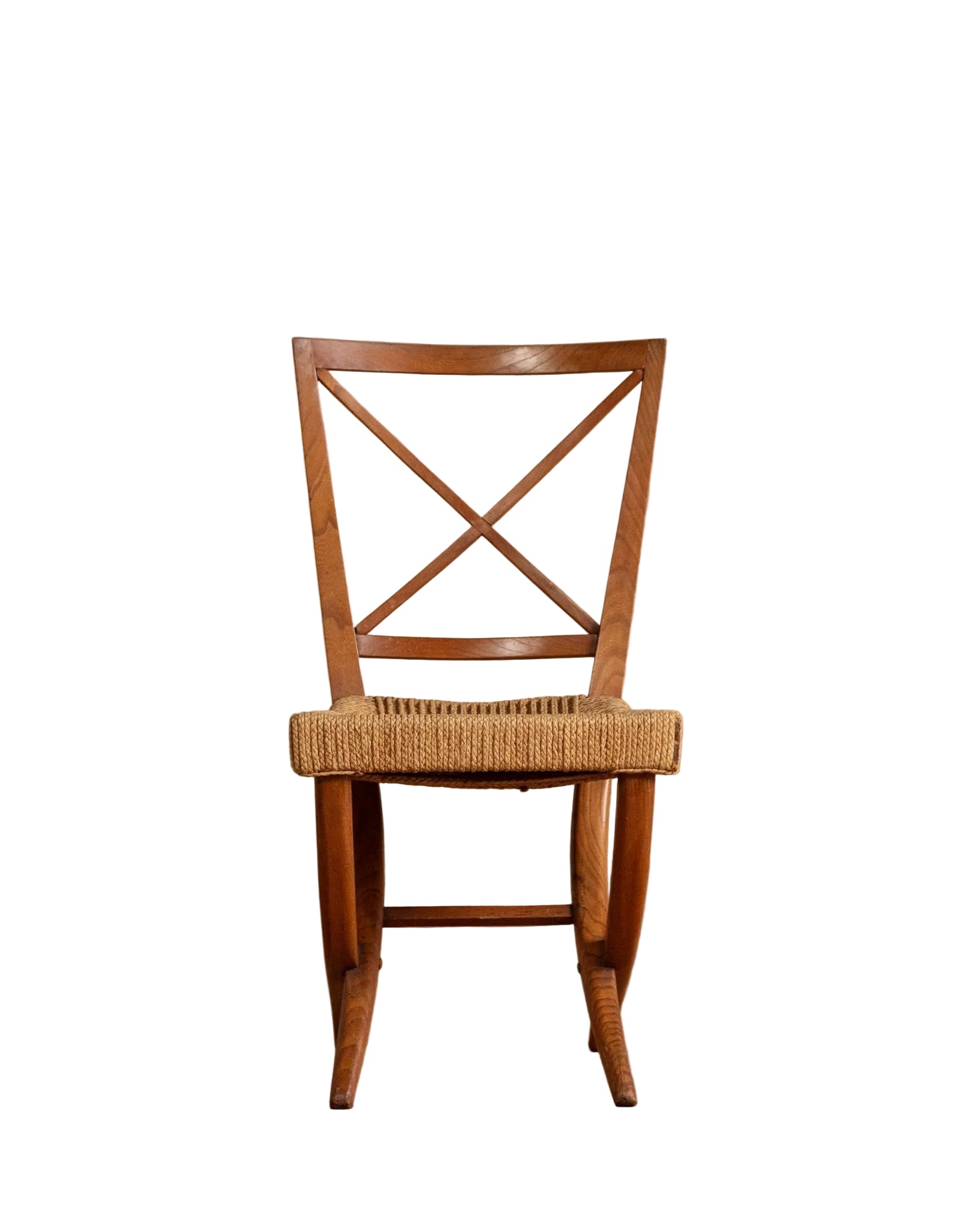 Wooden chair with woven seat on a wooden floor and beige wall background