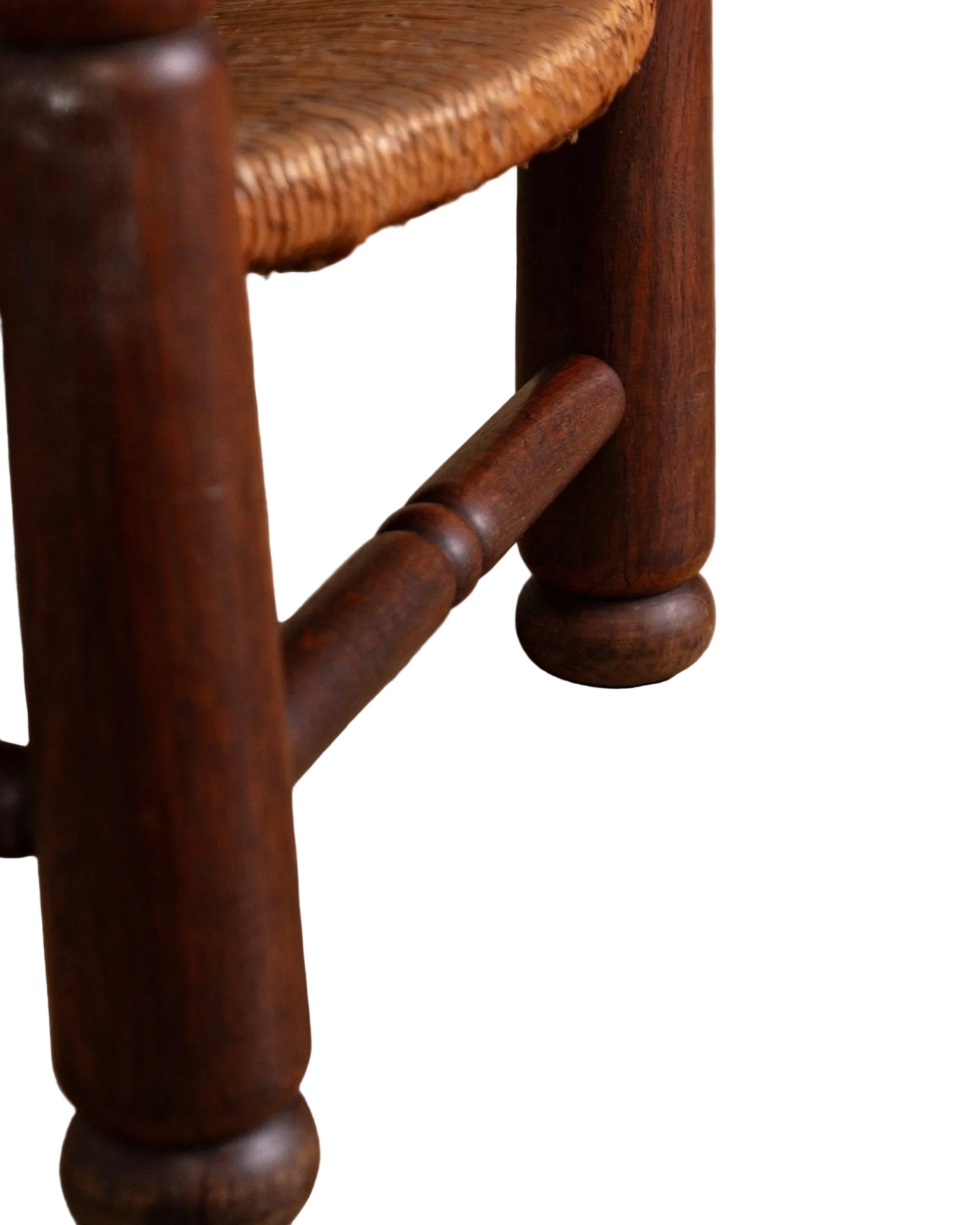 Close-up of a wooden chair leg on a wooden floor