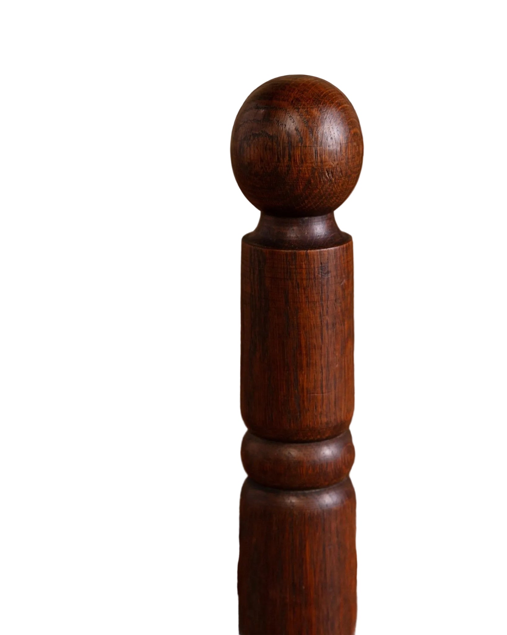 Close-up of a wooden chair with a woven seat on a blurred background