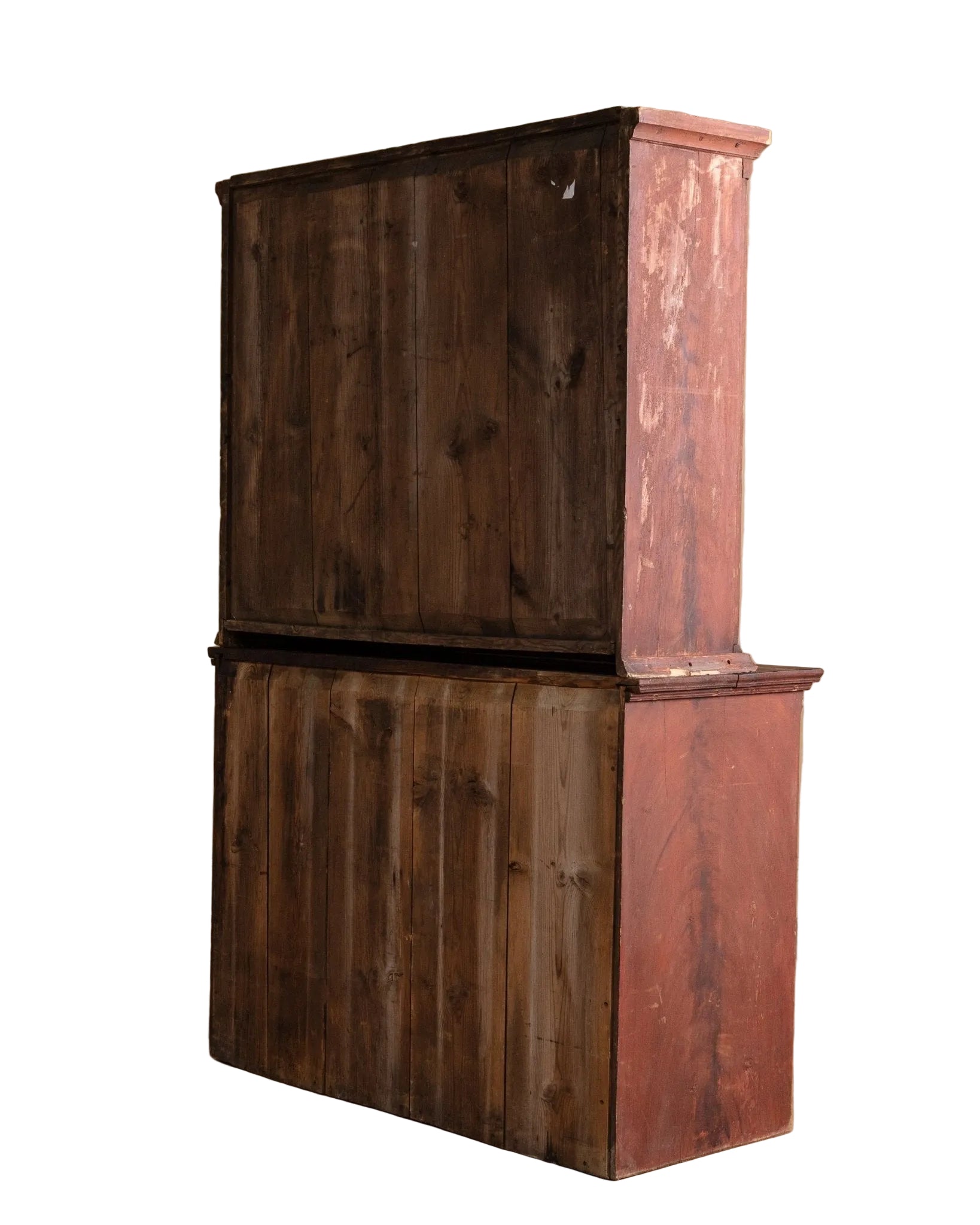Vintage wooden cabinet with a dark brown top and red-painted base against a beige wall.