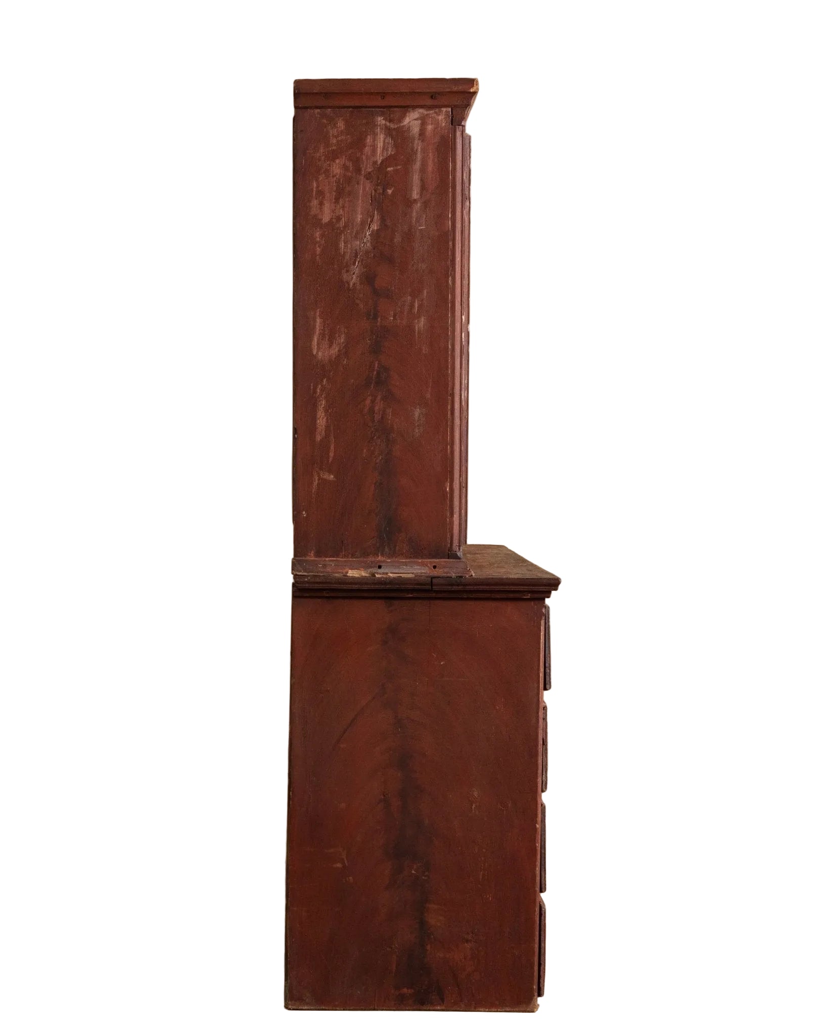 Tall wooden cabinet with a distressed finish against a beige wall.