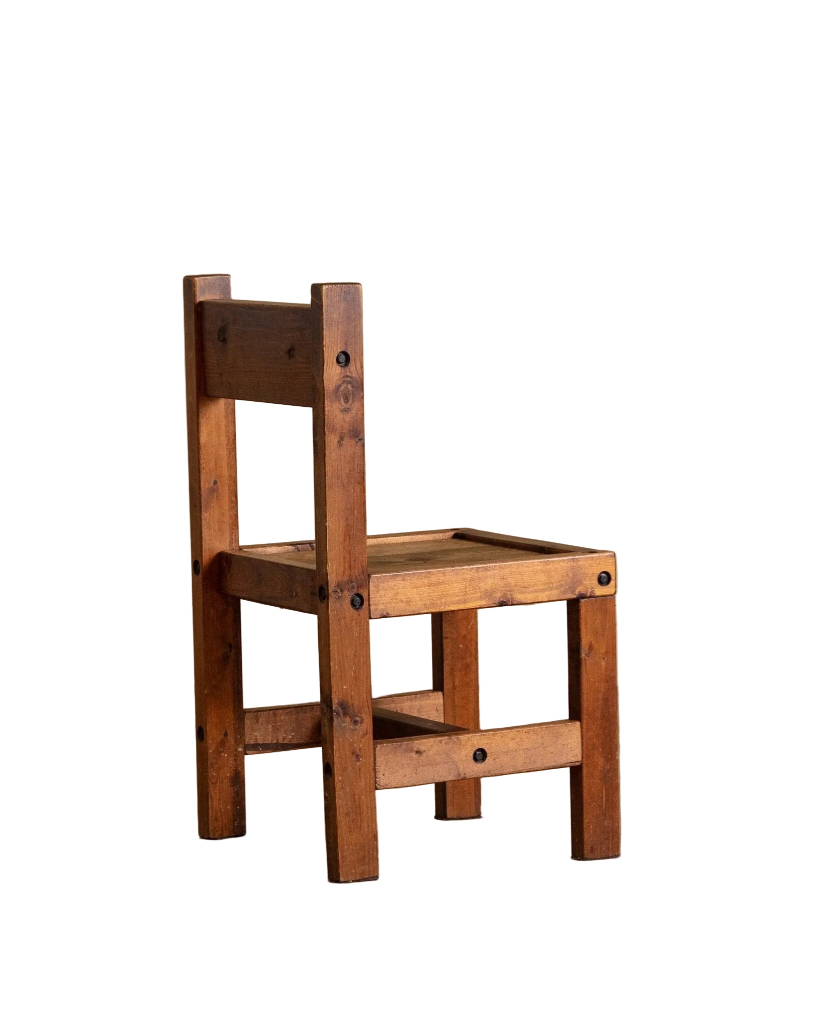Wooden chair on a wooden floor with a beige wall background