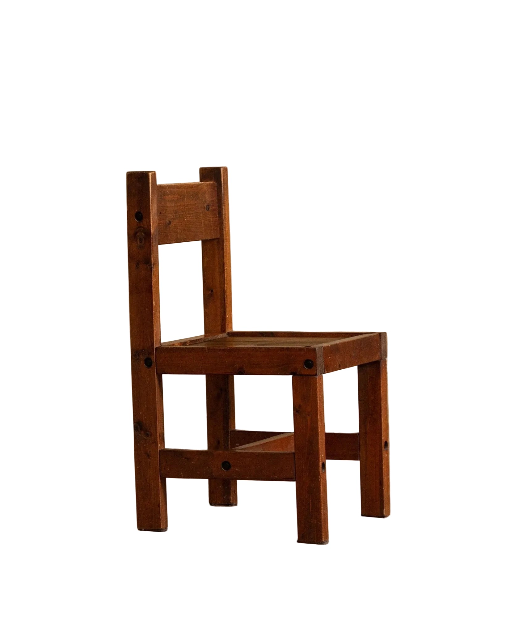 Wooden chair on a wooden floor with a beige wall background