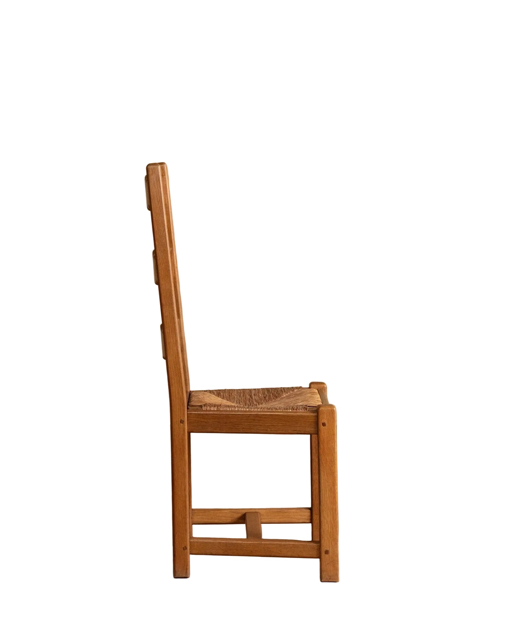 Wooden chair against a beige wall on a wooden floor