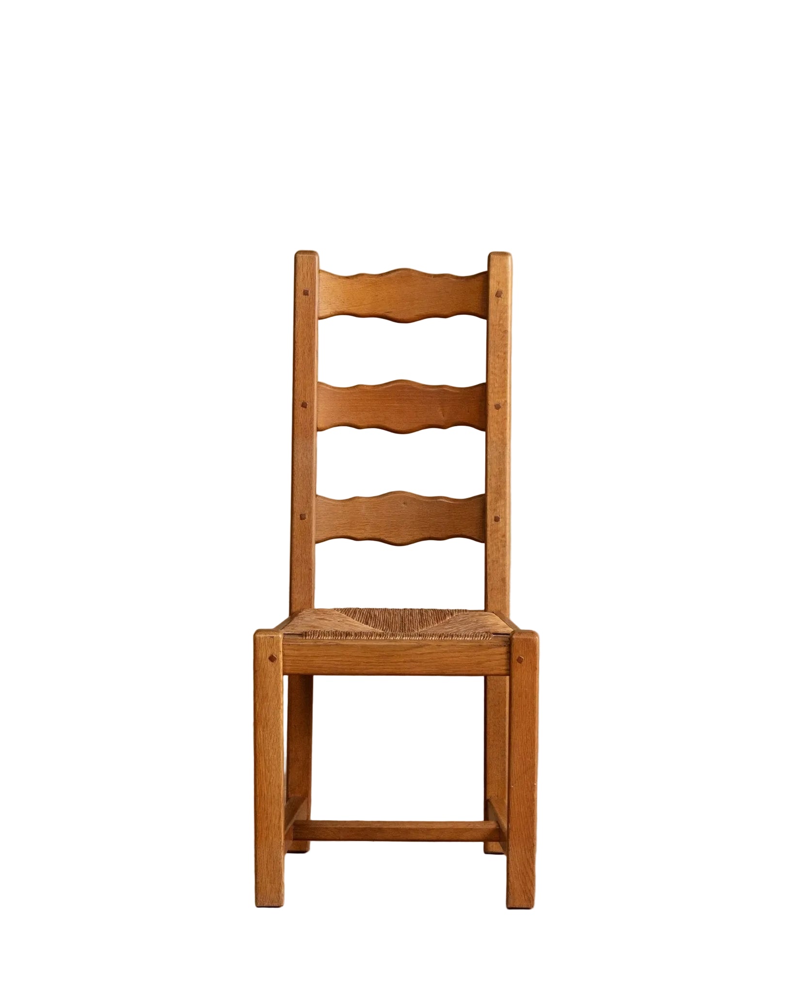 Wooden chair against a beige wall