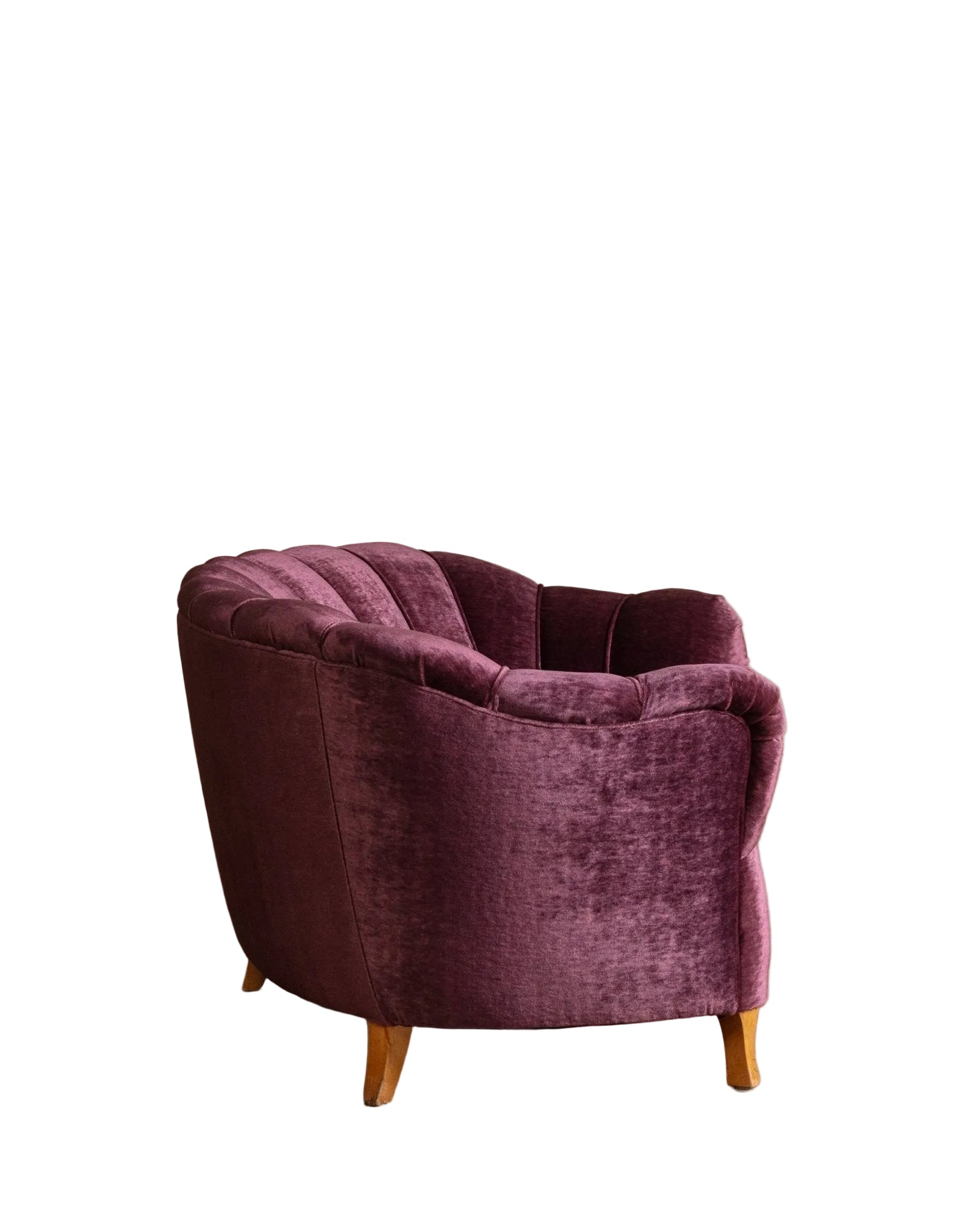 Purple armchair on a wooden floor with a beige wall background